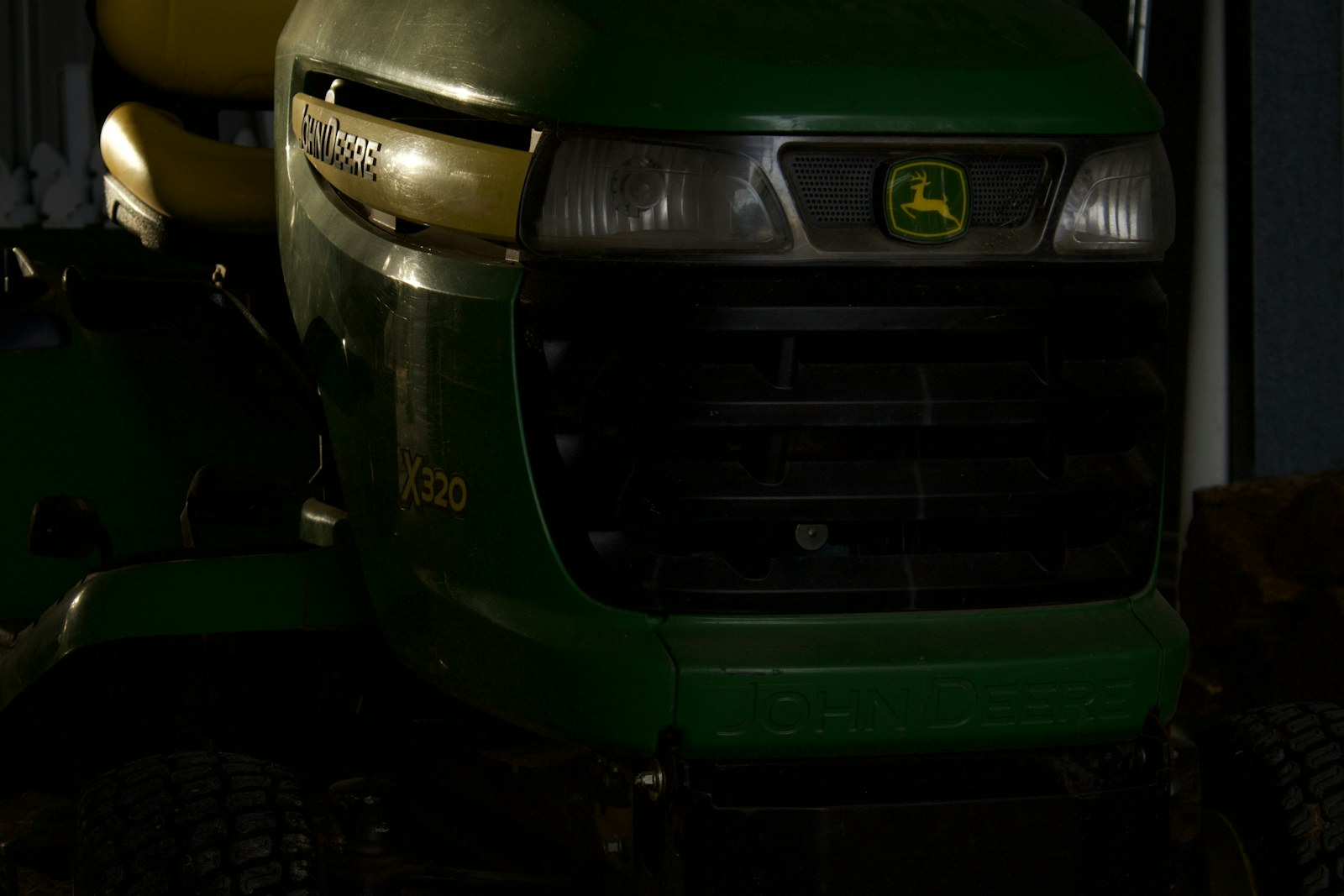 Riding lawn mower parked inside a residential garage